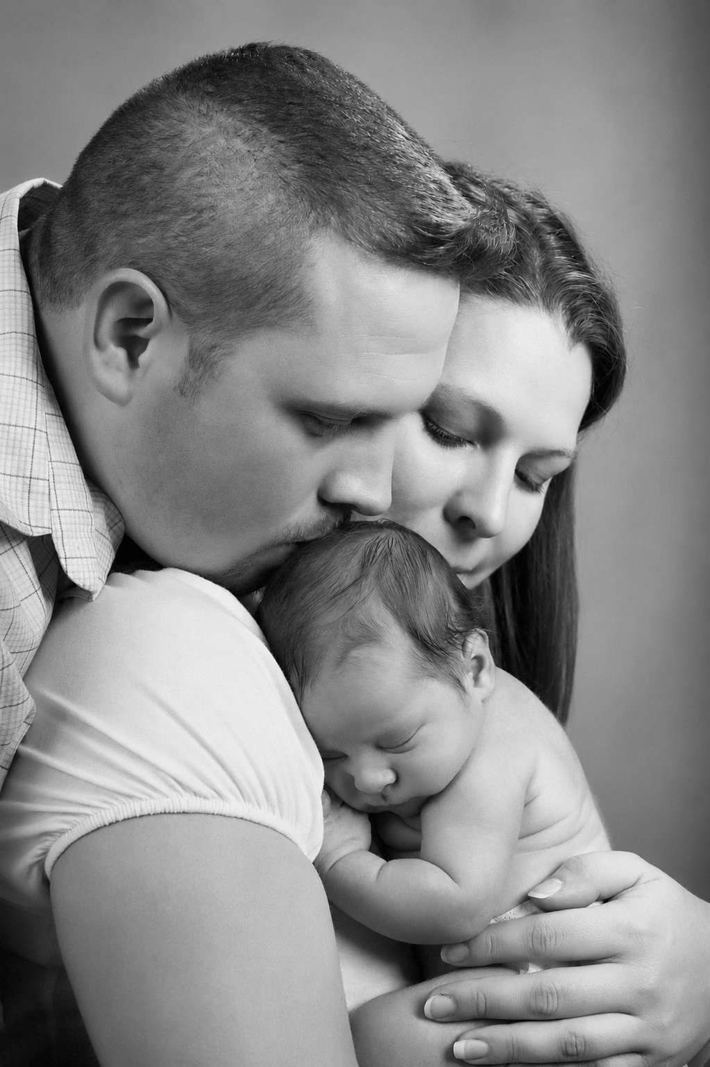 Portrait of a previous wedding couple and their new baby by Peter Farrar Portraits